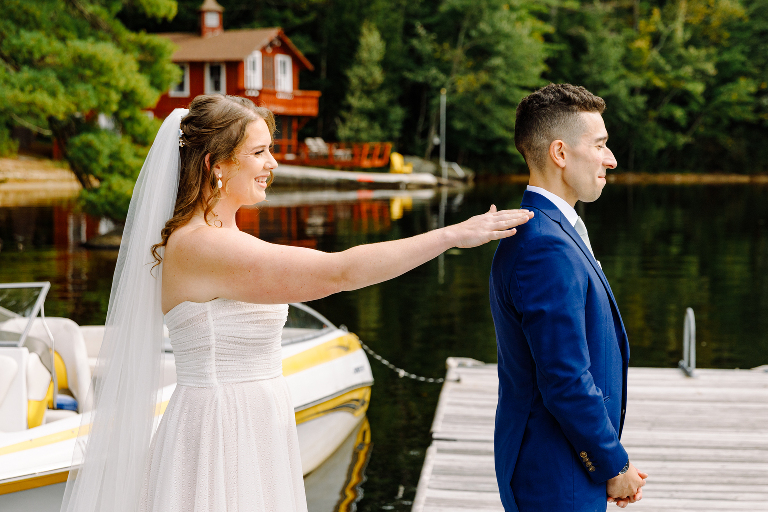 Bride about to touch the groom for the first look before their wedding ceremony at Tarry A While Resort in Bridgton Maine