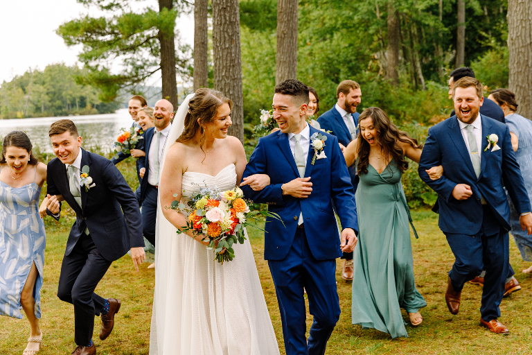 Fun and candid group wedding photo of the groom, bride, and bridal party at the Tarry A While Resort in Bridgton Maine