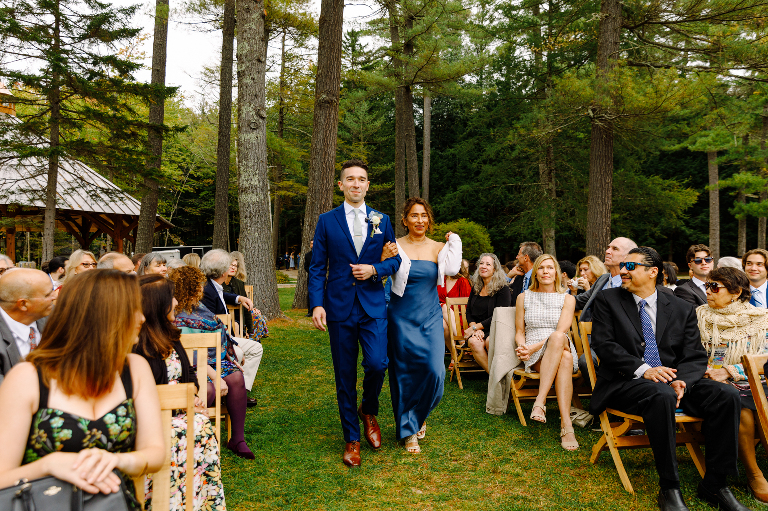 Groom walking his mother down the aisle before the wedding ceremony at the Tarry A While Resort in Bridgton Maine.