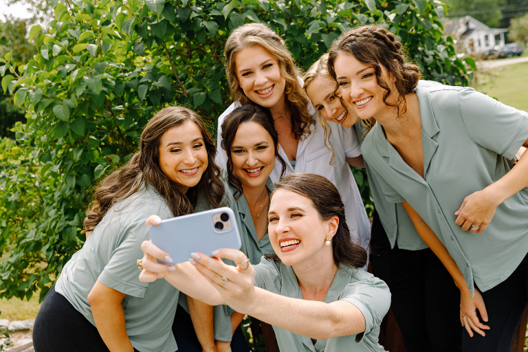 Bride and bridesmaids posing for a fun and candid wedding photo at Tarry A While Resort