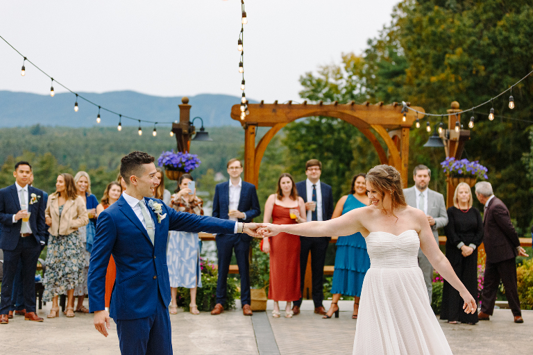 Bride and groom dancing together on the patio for their wedding reception at the Tarry A While Resort in Bridgton Maine by Kasey Ivan Photography