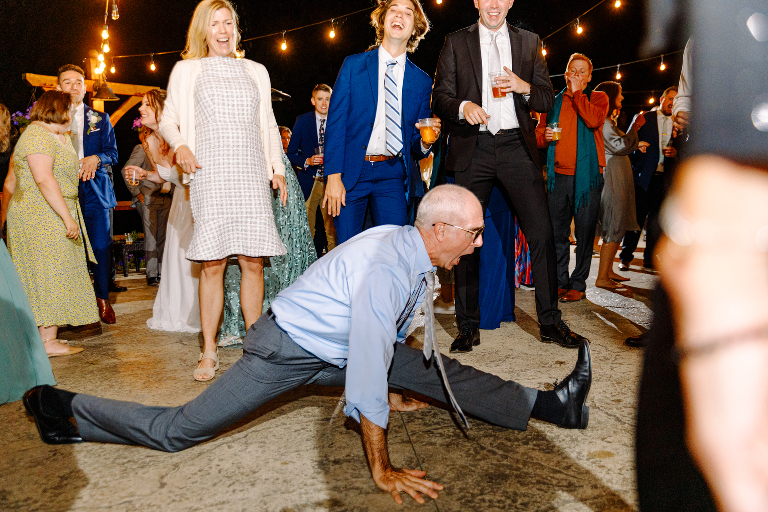 Fun and exciting dance floor reception photo as a man tries to do the splits at the Tarry A While Resort in Bridgton Maine by photographer Kasey Ivan Photography