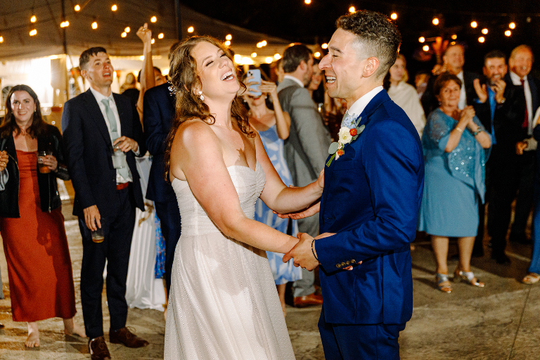 Bride and groom laughing together at the Tarry A While Resort in Bridgton Maine wedding reception by photographer Kasey Ivan