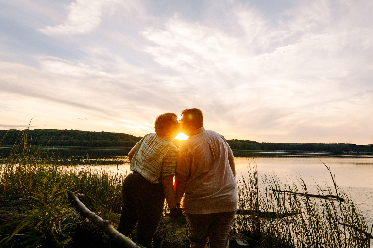 couple kissing at sunset at Gilsland Farm Audubon Center in Falmouth Maine